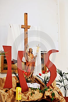 Wooden cross and Jesus figure decor in church. Easter concept