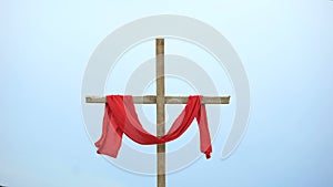 Wooden cross with red cloth wrapped around, crucifix and resurrection of Jesus