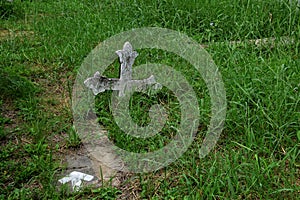 A wooden cross rose to the ground with natural background,