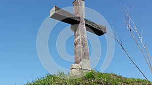 Wooden cross on the sky background