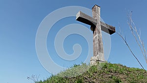 Wooden cross on the sky background