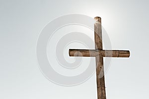 Wooden cross standing against a vivid blue sky