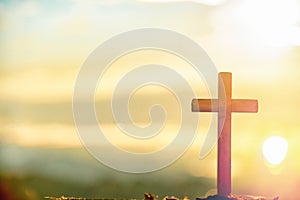 Wooden cross at sunrise in morning time with holy and light background .Crucifixion of jesus christ sign catholic religion concept