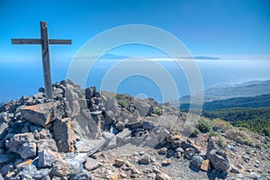 Wooden cross, Tenerife and La Gomera viewed from Pico de la Nieve at La Palma, Canary islands, Spain photo