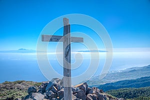 Wooden cross, Tenerife and La Gomera viewed from Pico de la Nieve at La Palma, Canary islands, Spain photo