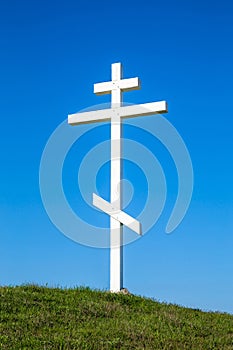 A wooden cross on top of a hill