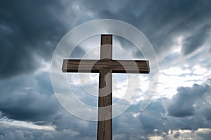 wooden cross under dramatic stormy sky