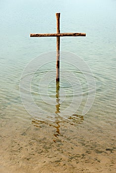 Wooden cross in the water