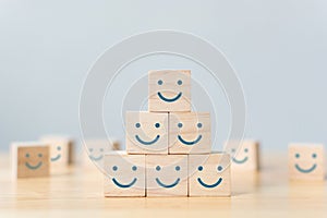 Wooden cube block shape with icon face smiley