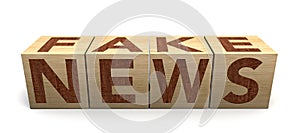 Wooden cube block on white background with word fake news. Concept. Junk news deliberate disinformation or hoaxes