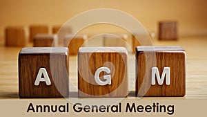 Wooden cube blocks of acronym AGM text word annual General Meeting