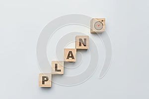 Wooden cube blocks with PLAN word with Target icon on white background. Business action plan, goals and strategy concept
