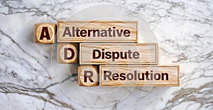 Wooden cube blocks of word text Alternative Dispute Resolution acronym ADR