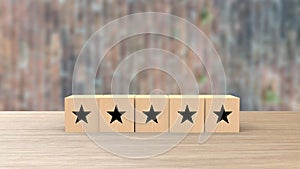 Wooden cube five black star review on blur wall of bricks. Service rating, satisfaction concept. reviews and comments google maps