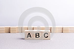 wooden cube with the letter from the ABC word. wooden cubes standing photo