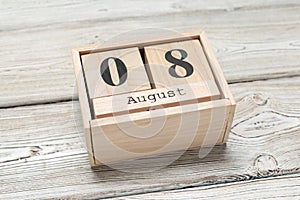 Wooden cube shape calendar for AUG 8 on wooden background