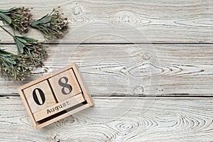 Wooden cube shape calendar for AUG 8 on wooden background