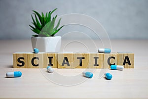 Wooden cube with text Sciatica. Medical concept. background photo