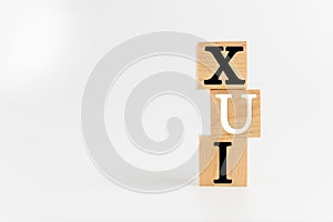 The Wooden cube on a white table with text UX, UI. Concept of development and design and development, user interface, user