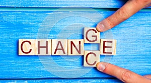 Wooden cube with word `change` to `chance` on wood table. Personal development and career growth or change yourself concept. conce