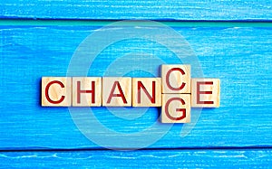 Wooden cube with word `change` to `chance` on wood table. Personal development and career growth or change yourself concept. conce