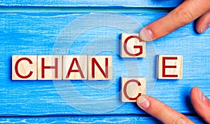 Wooden cube with word `change` to `chance` on wood table. Personal development and career growth or change yourself concept. conce