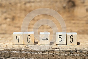 Wooden cubes From 4g To 5g with black arrow pointing On wooden background, mobile or technology concept