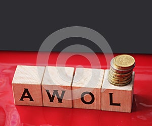 Wooden cubes with abbreviation AWOL, and coins on red background. Business financial concept of taxation, increase taxes and fees