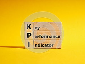 Wooden cubes with the the abbreviation KPI key performance indicator. Business concept