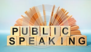 Wooden cubes with the abbreviation Public Speaking