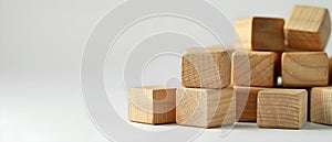 Wooden cubes being added to a group symbolizing completion and strategic positioning in a