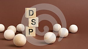 wooden cubes block with text dsp, brown background