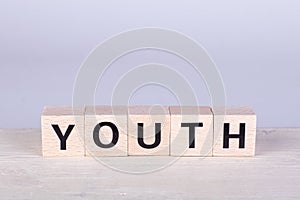 wooden cubes building the word Youth, white background