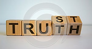 Wooden cubes and changes the word `Truth` to `Trust`. Beautiful white background