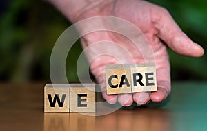 Wooden cubes form the expression 'we care'.