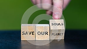 Wooden cubes form the expression 'save our planet' and save our souls.