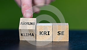 Wooden cubes form the German expressions \'Klima Krise\' and \'FlÃuechtlingskrise\'.