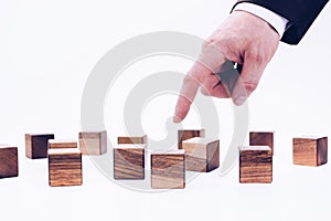 Wooden cubes and hand. The concept of people and personnel management. Manager and leader. Director