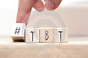 Wooden cubes with Hashtag tbt, meaning Throwback Thursday near white background social media concept photo