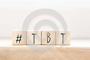 Wooden cubes with Hashtag tbt, meaning Throwback Thursday near white background social media concept photo