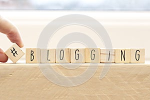 Wooden cubes with a hashtag and the word blogger, social media concept