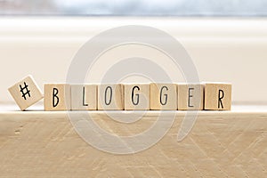 Wooden cubes with a hashtag and the word blogger, social media concept