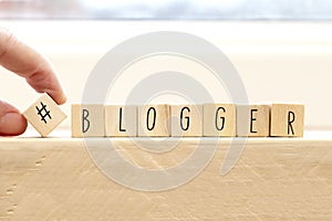 Wooden cubes with a hashtag and the word blogger, social media concept