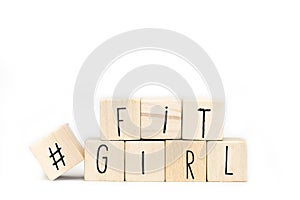Wooden cubes with Hashtag and the word Fitgirl isolated on white background, healthy social media concept photo