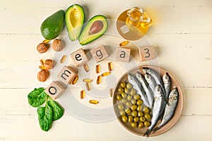 Wooden cubes, healthy products with high omega 3 and fish oil pills on white table