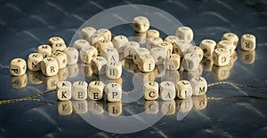 Wooden cubes with keep calm inscription strung on a thread