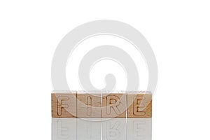 Wooden cubes with letters fire on a white background