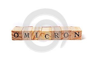 Wooden cubes with letters stacked in the word omicron. Isolate