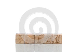 Wooden cubes with letters stead on a white background photo