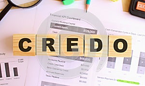 Wooden cubes with letters on the table in the office. Text CREDO.